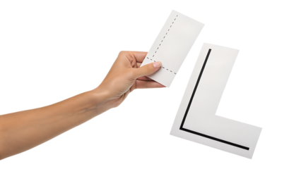 A hand gently holds a white card piece marked with dotted lines, positioning it near a ready-made capital letter L, isolated for digital design.