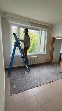 Man on ladder painting Apartment White in Time Lapse Home Renovation project takes place during the day