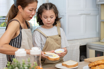 family time, breakfast, activities together during the holidays. Mother and daugther are having a meal together during the holidays. New home for family on morning, enjoy, weekend, vacant time