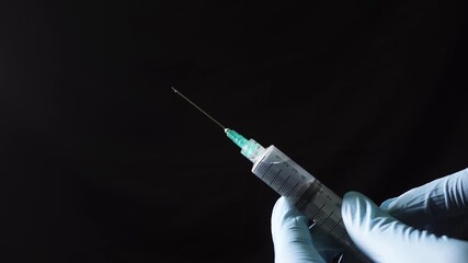 Close-up shot of a medical professional uncapping a syringe needle before giving medication to a patient, highlighted against a dark background. - Powered by Adobe