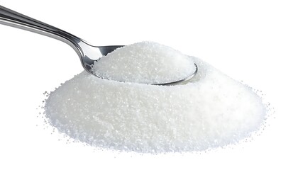 Glossy pile of granulated sugar holds a spoonful, bright on a white background, close-up studio shot