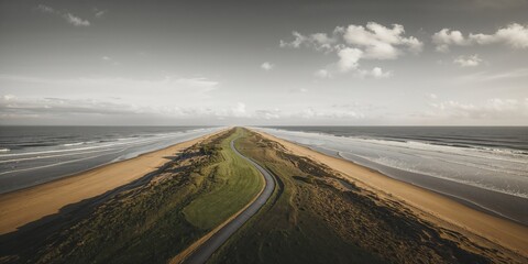 Birds-eye shot of a beach trail in grayscale with ocean waves, highlighting erosion concerns and shoreline stability
