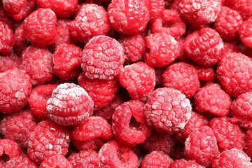 Frozen ripe raspberries as background, top view