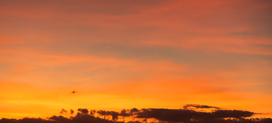 Dramatic sunset sky with clouds. Evening sky colors.
