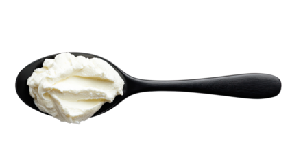 A black spoon holds a dollop of creamy white substance against a black background