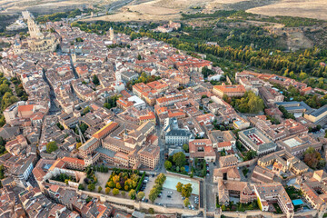 Aerial view of historic center of Segovia with medieval streets, stone buildings, central square.