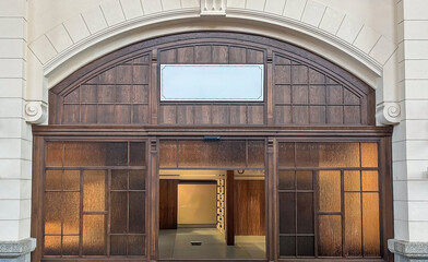 Entrance to historic ticket office in Gdansk with wooden facade, arched architecture. Poland.