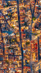 Illuminated urban grid of Getsemani Cartagena Colombia. Colorful rooftops and evening streets. Dron.