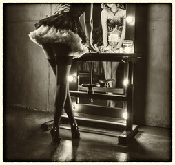 art sepia black and white color, retro lady long legs short dress stockings high heels back rear view looking into mirror vintage lamps. sexy woman burlesque show dancer actress flapper girl 20s roar