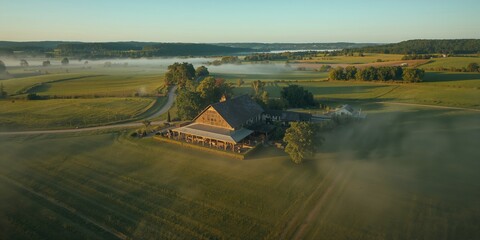 Birds eye perspective of a farm with a wedding celebration area, highlighting rustic event arrangements