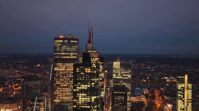 Aerial view of Frankfurt am Main skyline at night. Illuminated skyscrapers and modern architecture in Germany's financial district