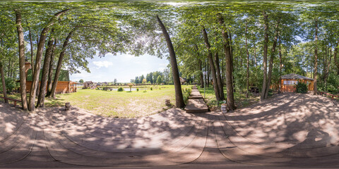 3D spherical panorama with 360 viewing angle. Ready for virtual reality or VR. Full equirectangular projection. Cold blue sky with green grass and with some trees at summer.