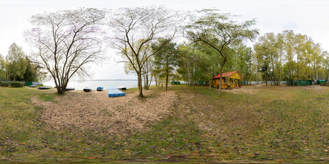 A full seamless spherical HDRI panorama with a 360-degree view of a forest recreation area. A green lawn for camping. A recreation center near water. VR content.