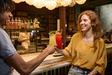 Woman receiving a cocktail at the bar
