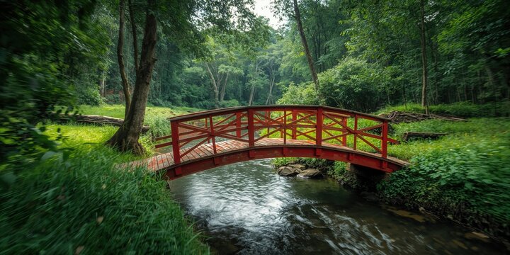 Red wooden bridge over a river in lush jungle landscape, summer travel scene natural scenery and forest preservation