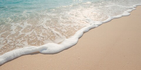 Detail of a coral sand beach with white sea foam on the surface, illustrating coastal preservation challenges