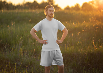 Mockup of white t-shirt, shorts for a man with long hair, beard, front view, suit for design, print, branding.