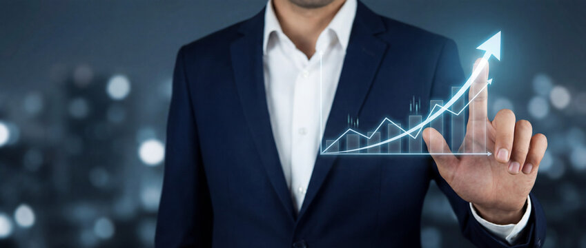 A businessman in a suit interacting with a glowing virtual growth chart showing upward financial trends, digital bars, and an arrow symbolizing success and analytics against a blurred city background. - Powered by Adobe
