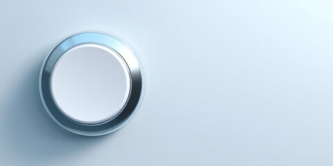 Obraz premium Close-up of a modern metallic circular button on a smooth light blue surface with soft shadows and reflective highlights
