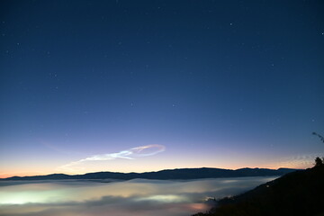 beautiful city lights through the fog and clouds