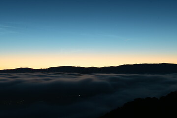 beautiful city lights through the fog and clouds