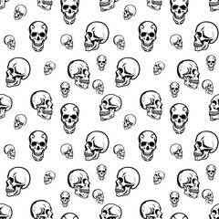 A seamless black and white pattern of human skulls in profile and front view. Spooky, gothic design for fabrics or backgrounds.