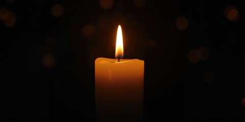 Detailed view of a single candles flame and wax, serving as a source of soft illumination, World Candle Day