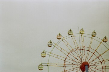 A Colorful Ferris Wheel Against a Clear Sky at An Amusement Park