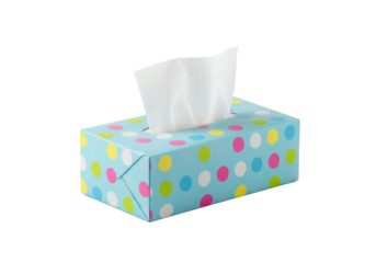 A pastel light blue rectangular box of disposable tissues, adorned with vibrant yellow, pink, and green polka dots, rests on a seamless white background with subtle reflection. Concept for hygiene
