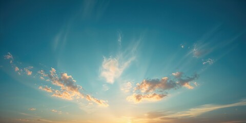 Naklejka premium Sunset-lit blue sky with subtle cloud formations, ideal for nature scene backdrops