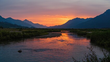 Fototapeta premium Sunset scene with water and mountain landscape, vibrant sky and evening light, summer setting, World Environment Day