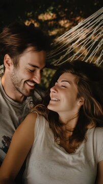 Couple relaxing in a hammock, enjoying a moment of closeness and laughter