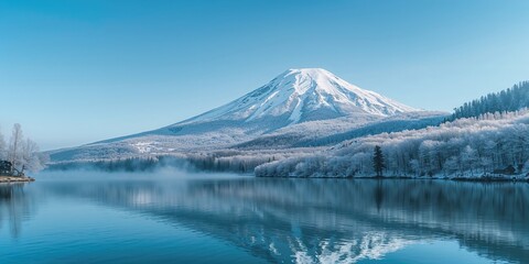 Snow-covered mountains and a lake with clear blue sky in winter, serving as a scenic background for landscape photography