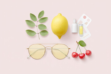 Minimalist arrangement with lemon, sunglasses, and cherries on pink background
