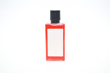 Small, clear glass bottle containing red liquid (oil, serum, or perfume) with a black cap and blank white label, isolated on white. Ideal for cosmetic product mockup, sample size, or beauty concept.