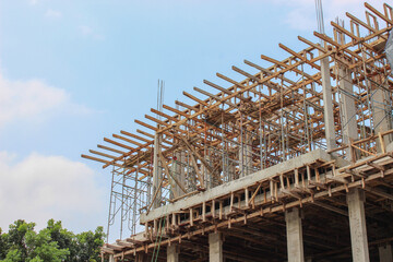 Main reinforced concrete structure with columns and beams and wooden formwork for preparation of upper floor slab casting in a luxury residential construction project.