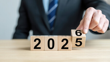 Changing the year to 2026 with wooden blocks on desk