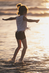 Happy kid jump on sea water
