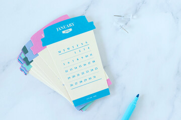 2026 calendar on paper coffee cups. Top view. Copy space. New year planning and goals, business concept.