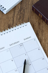 Calendar and holy bible book on wooden table. Christian Sabbath day rest, biblical concept.