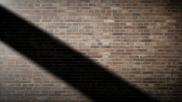 Static shot of a brick wall with dynamic shadows cast by soft light showcasing the texture and color variation of the bricks throughout the clip as it transitions.