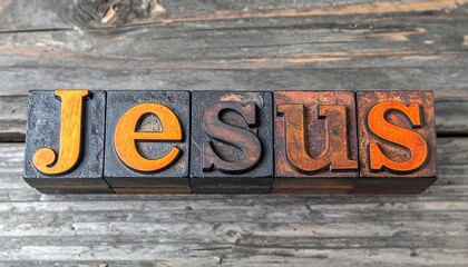 The Word JESUS Spelled in Vintage Wooden Letterpress Blocks on Rustic Wood