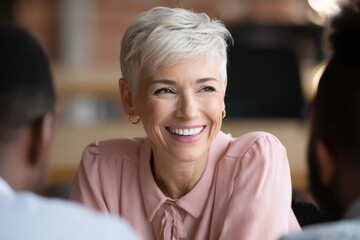 Smiling Professional Woman Engaged in Conversation at Modern Workplace.