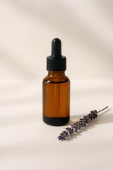 A bottle of essential oil with a purple flower next to it