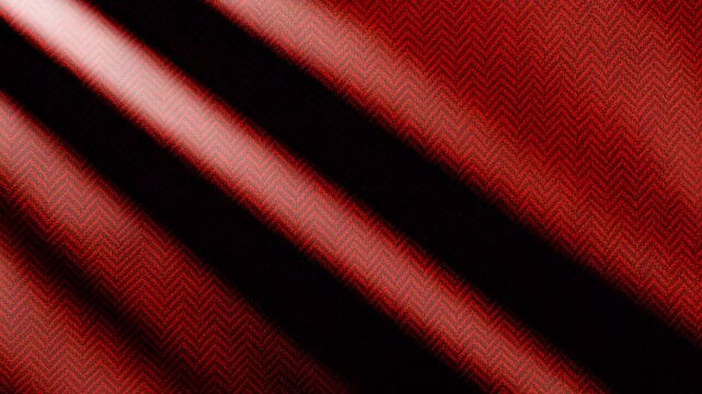 Close-up view of richly textured red fabric with intricate herringbone pattern gently draped and illuminated in soft light showcasing depth and detail in the weaves and colors