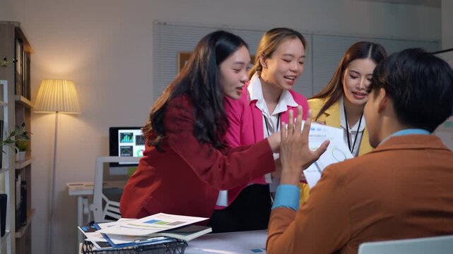 Angry asian businesswoman shouting at a male colleague during a stressful business meeting. The corporate team is having a heated argument