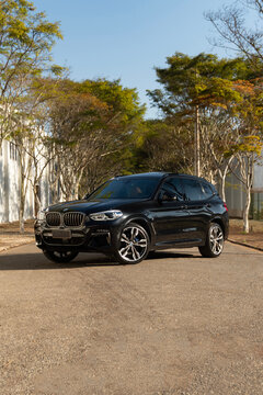Black BMW X3 M40i front three quarter view, Luxury sport SUV on paved road