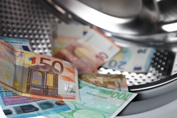 Many euro banknotes in washing machine, closeup