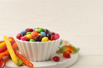Delicious colorful candies on white table, closeup. Space for text