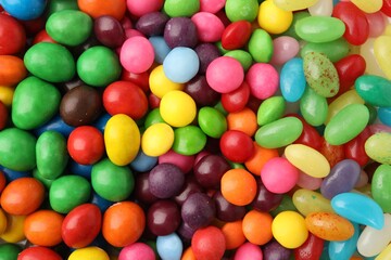 Many delicious colorful candies as background, closeup